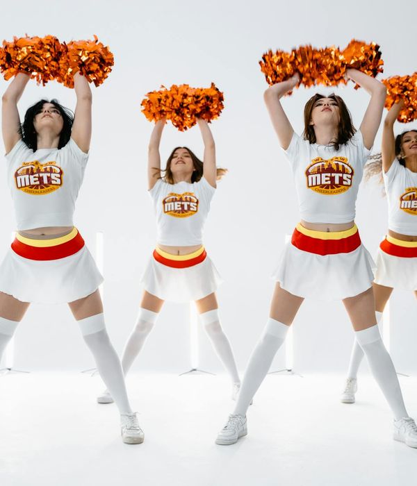 Woman performing a low-intensity cardio movement in a bright studio.